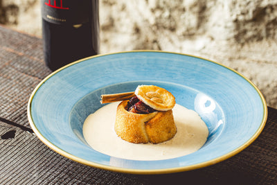 Chestnut and sour cherry chimney cake with cinnamon sauce